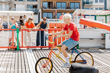 Art von verrücktem Fahrrad während Damen zuschauen.